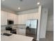 Modern kitchen with stainless steel appliances and island at 2720 Pierr St, Davenport, FL 33837