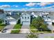 Aerial view of a two-story house with gray siding and a paver driveway at 3004 Ballad Rd, Kissimmee, FL 34746