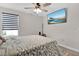 Bedroom with a ceiling fan, large TV, and window blinds at 3004 Ballad Rd, Kissimmee, FL 34746
