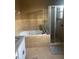 Bathroom with a large garden tub and walk-in shower at 3077 Brenton Manor Loop, Winter Haven, FL 33881
