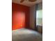 Simple bedroom with orange accent wall and neutral carpeting at 3077 Brenton Manor Loop, Winter Haven, FL 33881