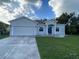 Two-story house with a two-car garage and landscaping at 3077 Brenton Manor Loop, Winter Haven, FL 33881
