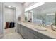 Double vanity bathroom with gray cabinets, quartz countertops, and a large walk-in shower at 5075 Twin Lakes Blvd, Saint Cloud, FL 34772