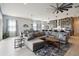 Spacious living room with a large sectional sofa, coffee table, and access to the kitchen and dining area at 5075 Twin Lakes Blvd, St Cloud, FL 34772