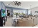 Open living space showcasing a sectional sofa, large TV, and sliding glass doors leading to the patio at 5075 Twin Lakes Blvd, St Cloud, FL 34772