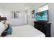 Bedroom with a queen-size bed, TV, and coastal decor at 5075 Twin Lakes Blvd, St Cloud, FL 34772