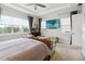 Bright main bedroom features a king bed, sitting area, and wall-mounted TV at 5075 Twin Lakes Blvd, St Cloud, FL 34772