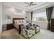 Main bedroom with king-size bed, two armchairs, and plenty of natural light from large windows at 5075 Twin Lakes Blvd, St Cloud, FL 34772