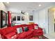 Game room with red sectional sofa, air hockey, and movie posters creating a fun and playful atmosphere at 5075 Twin Lakes Blvd, St Cloud, FL 34772