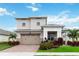 Two-story house with a two-car garage and brick driveway at 5075 Twin Lakes Blvd, Saint Cloud, FL 34772