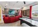 Fun game room features a red sectional sofa, air hockey table, and an extensive Pez dispenser collection at 5075 Twin Lakes Blvd, St Cloud, FL 34772