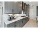 Modern kitchen with gray cabinets, white quartz countertops, and stainless steel appliances at 5075 Twin Lakes Blvd, St Cloud, FL 34772