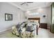Spacious main bedroom with king-size bed, two accent chairs, and a neutral color palette at 5075 Twin Lakes Blvd, St Cloud, FL 34772