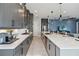 Modern kitchen with long island, gray cabinets, and white quartz countertops at 5075 Twin Lakes Blvd, St Cloud, FL 34772