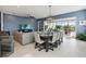 Bright dining room features a large table with seating for six, and is open to the living room and kitchen at 5075 Twin Lakes Blvd, St Cloud, FL 34772