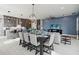 Open concept kitchen boasts modern gray cabinetry, expansive countertops, and an island with seating at 5075 Twin Lakes Blvd, St Cloud, FL 34772