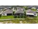 Aerial view showcasing houses with screened patios and lush green lawns at 5075 Twin Lakes Blvd, St Cloud, FL 34772