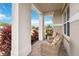 Front porch with wicker chairs and columns at 5075 Twin Lakes Blvd, Saint Cloud, FL 34772