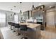 Modern kitchen with large island, gray cabinets, quartz countertops and breakfast bar at 5075 Twin Lakes Blvd, St Cloud, FL 34772