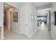 Spacious hallway with light gray walls and wood-look tile floors, offering views into other rooms at 5075 Twin Lakes Blvd, St Cloud, FL 34772