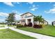 Two-story house with a two-car garage and lush landscaping at 5075 Twin Lakes Blvd, St Cloud, FL 34772