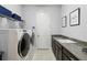 Laundry room with Whirlpool washer and dryer, granite countertop and ample storage at 5075 Twin Lakes Blvd, St Cloud, FL 34772
