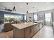 Open concept kitchen with large island and breakfast bar, overlooking the living room at 5075 Twin Lakes Blvd, St Cloud, FL 34772