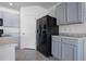 Modern kitchen with gray cabinets and stainless steel appliances at 615 Squires Grove Dr, Winter Haven, FL 33880