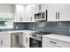 Contemporary kitchen featuring white shaker cabinets and stainless steel appliances at 639 Shore Acres Dr, Lakeland, FL 33801