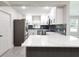 Modern kitchen with white cabinets, quartz countertops, and a stylish backsplash at 639 Shore Acres Dr, Lakeland, FL 33801