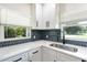 Updated kitchen with white cabinets, blue hexagon backsplash and stainless steel appliances at 639 Shore Acres Dr, Lakeland, FL 33801