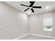 Simple bedroom with ceiling fan and one window at 639 Shore Acres Dr, Lakeland, FL 33801