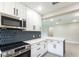 Modern kitchen features stainless steel appliances and stylish hexagon backsplash at 639 Shore Acres Dr, Lakeland, FL 33801