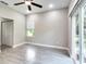 Bedroom with window, ceiling fan, and grey tile floors at 639 Shore Acres Dr, Lakeland, FL 33801