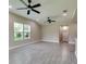 Spacious living room with tile flooring and two ceiling fans at 639 Shore Acres Dr, Lakeland, FL 33801