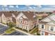 Aerial view of charming townhouses with inviting landscaping and ample parking at 7585 Sunny Dreams Ln, Kissimmee, FL 34747