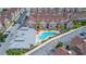 Aerial view of community with pool, clubhouse, and townhouses at 7585 Sunny Dreams Ln, Kissimmee, FL 34747