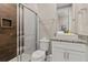 Clean bathroom with a walk-in shower, toilet, and granite vanity at 7585 Sunny Dreams Ln, Kissimmee, FL 34747