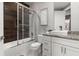 Bathroom with tub/shower combo, granite vanity, and modern decor at 7585 Sunny Dreams Ln, Kissimmee, FL 34747