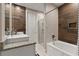Modern bathroom with granite countertop, soaking tub and walk-in shower at 7585 Sunny Dreams Ln, Kissimmee, FL 34747