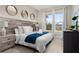 Bright bedroom with large windows and a plush bed at 7585 Sunny Dreams Ln, Kissimmee, FL 34747