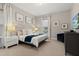 Main bedroom with a king-size bed, nightstands, and a wood-paneled headboard at 7585 Sunny Dreams Ln, Kissimmee, FL 34747