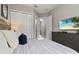 Bedroom with king-size bed, wood accent wall, and flat-screen TV at 7585 Sunny Dreams Ln, Kissimmee, FL 34747
