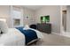 Comfortable bedroom with dresser, TV, and ensuite bathroom access at 7585 Sunny Dreams Ln, Kissimmee, FL 34747
