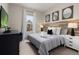 Bedroom with king-size bed, wood accent wall, and flat-screen TV at 7585 Sunny Dreams Ln, Kissimmee, FL 34747