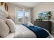 Bedroom with large windows, comfortable bed, and a dresser at 7585 Sunny Dreams Ln, Kissimmee, FL 34747