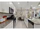 Modern kitchen with stainless steel appliances and granite countertops at 7585 Sunny Dreams Ln, Kissimmee, FL 34747