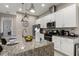 Modern kitchen with island, stainless steel appliances, and granite countertops at 7585 Sunny Dreams Ln, Kissimmee, FL 34747
