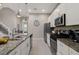 Modern kitchen with stainless steel appliances and granite countertops at 7585 Sunny Dreams Ln, Kissimmee, FL 34747