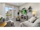 Bright living room with comfy sofas, a large TV, and sliding glass doors leading to a patio at 7585 Sunny Dreams Ln, Kissimmee, FL 34747